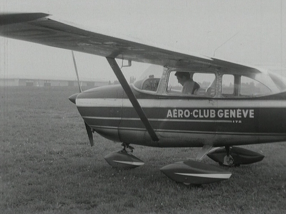 Gilbert Bécaud pilotant un avion en 1965. [RTS]